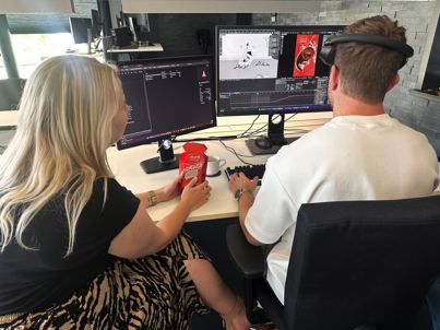 Timo and Kelly behind desk