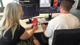 Timo and Kelly behind desk