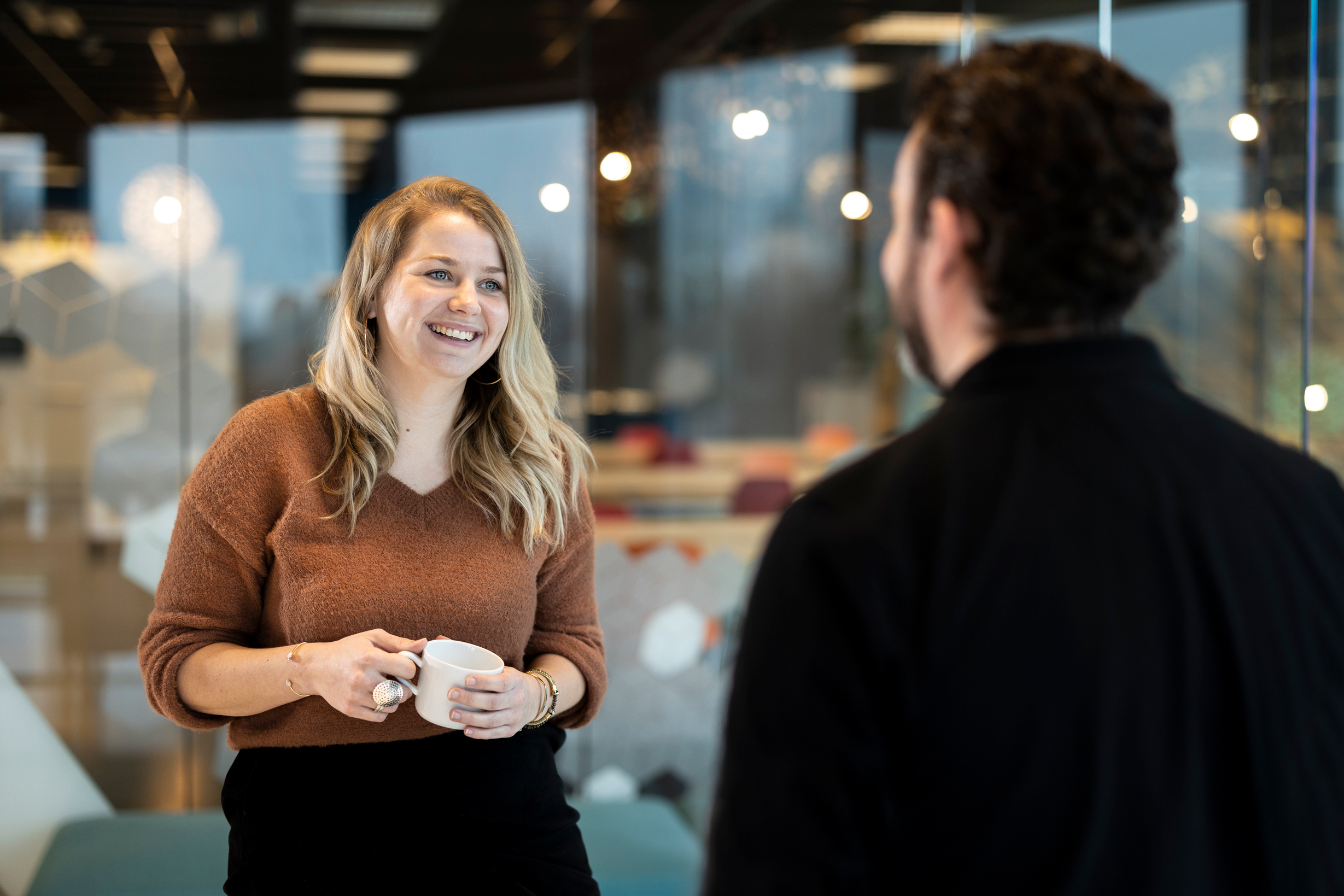Kelly smiling in front of window