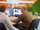 Martijn and Jeroen sit behind desk
